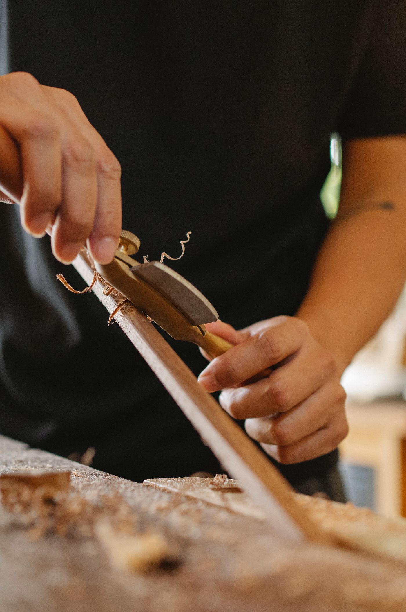 A hand plane taking a shaving