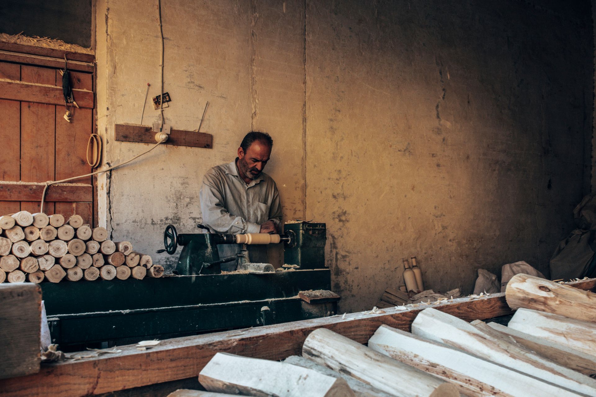 A cabinetmaker at the bench in a low-lit shop
