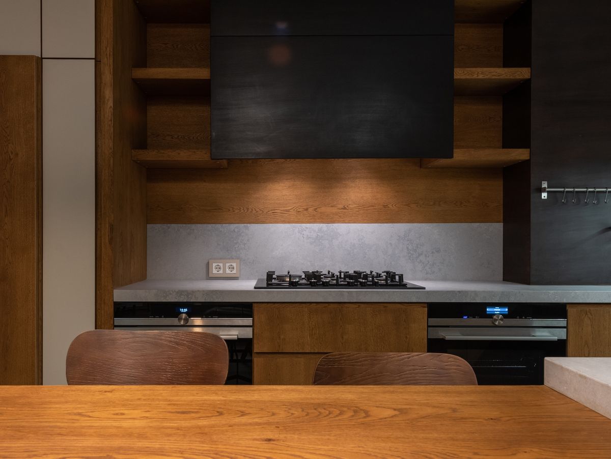 Built-in timber shelving around a hearth