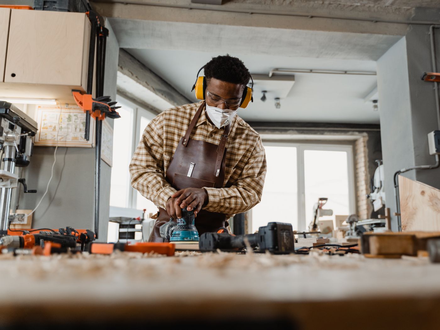 An apprentice at the table saw